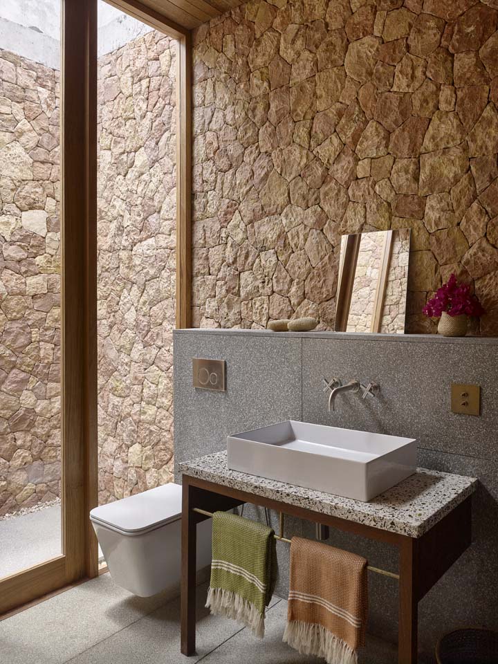 a bathroom opening onto a stone courtyard
